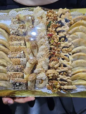 a tray of different types of pastries on a table at Fassia in Fès