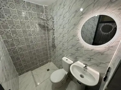 a bathroom with a toilet and a sink and a mirror at Charming Spacious Gem Near Fes Medina in Fès