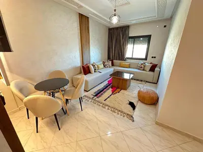 a living room with a couch and a table and chairs at Charming Spacious Gem Near Fes Medina in Fès