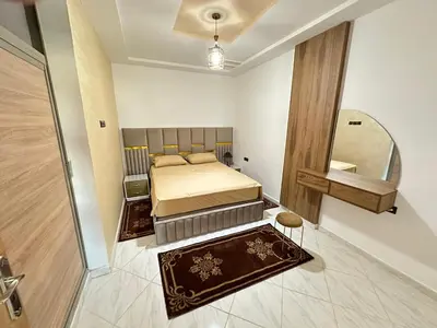a small bedroom with a bed and a mirror at Charming Spacious Gem Near Fes Medina in Fès