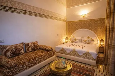 a bedroom with a bed and a couch at Riad rayhane fez in Fès