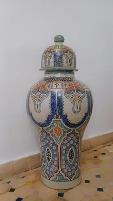 a large vase sitting on a tile floor at Riad rayhane fez in Fès