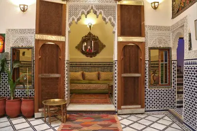a lobby of a mosque with a couch and a mirror at Riad rayhane fez in Fès