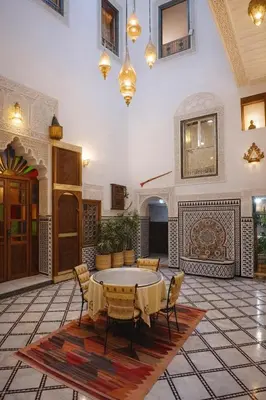 a large room with a table and chairs in it at Riad rayhane fez in Fès