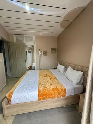 a bedroom with a large bed in a room at Gîte - Auberge PYRAMIDES Bab Boudir in Bab Boudir