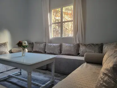 a living room with a couch and a table at Ourika Valley Haven - Breathe, Relax, Unwind in Ourika