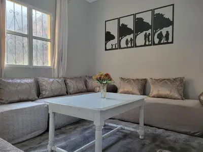 a living room with a couch and a white table at Ourika Valley Haven - Breathe, Relax, Unwind in Ourika