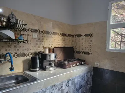 a kitchen with a stove and a sink at Ourika Valley Haven - Breathe, Relax, Unwind in Ourika