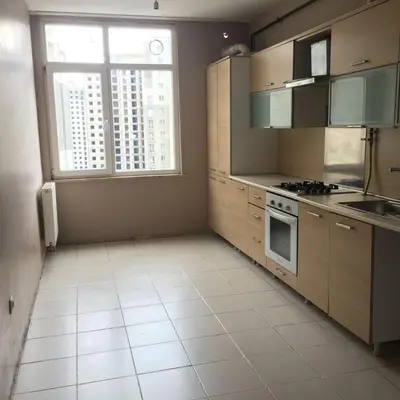 a kitchen with wooden cabinets and a large window at aLO MARRAKECH in Kasba Aït Youdi