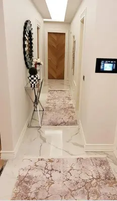 a hallway with a marble floor and a hallway with a door at aLO MARRAKECH in Kasba Aït Youdi
