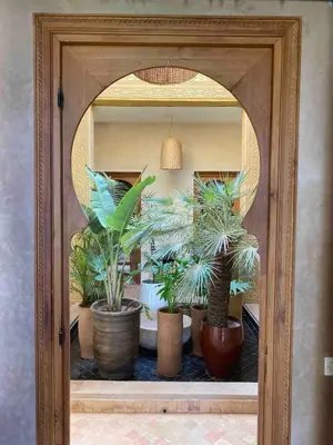 a window with a bunch of potted plants in it at Villa les Portes de l'Atlas - MARRAKECH in Marrakech