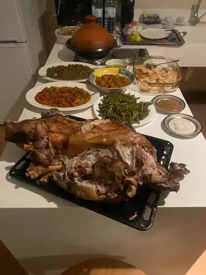 a turkey on a black plate on a table with other food at Villa les Portes de l'Atlas - MARRAKECH in Marrakech