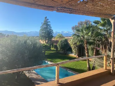a view from the balcony of a house with a swimming pool at Villa les Portes de l'Atlas - MARRAKECH in Marrakech