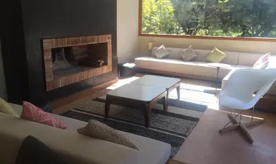 a living room with a couch and a fireplace at Villa les Portes de l'Atlas - MARRAKECH in Marrakech