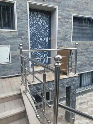 a front door of a house with a metal railing at Dar diafa in Imouzzer Kandar