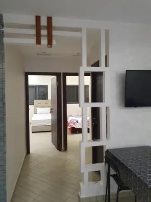 a living room with a room with a bed and a television at Dar diafa in Imouzzer Kandar