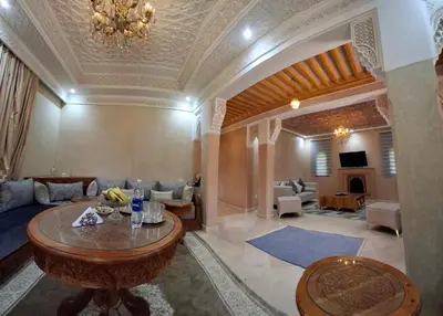 a living room with a couch and a table at Villa Hamza Marrakech in Bou Touil