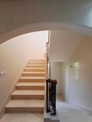 a staircase in a house with a stair case at Villa Hamza Marrakech in Bou Touil