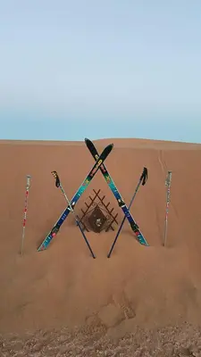 a group of four ski poles in the sand at Akwabir camp in El Gouera