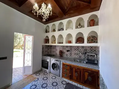 a kitchen with a stove and a dishwasher at Villa SANDI in Ouled el guerne