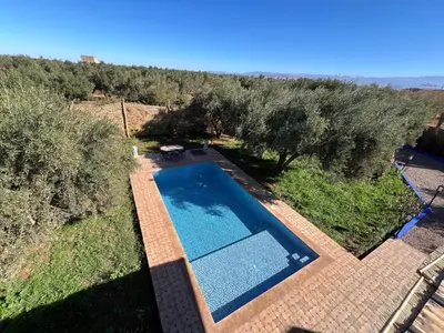 an overhead view of a swimming pool with trees at Villa SANDI in Ouled el guerne