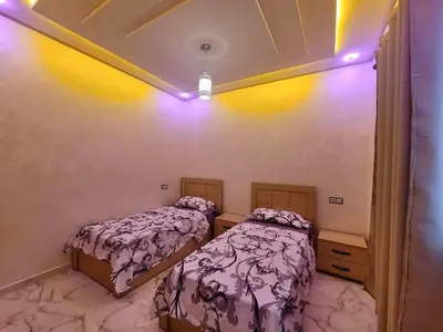a bedroom with two beds and a ceiling at Appartement deux chambres avec parking gratuit in Azrou