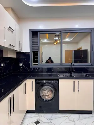 a kitchen with a washing machine and a sink at Appartement deux chambres avec parking gratuit in Azrou