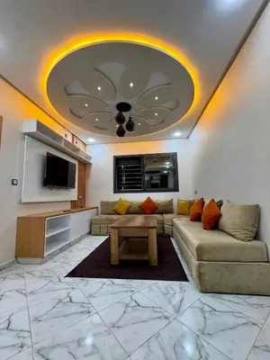 a living room with a couch and a tv at Appartement deux chambres avec parking gratuit in Azrou