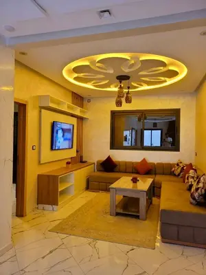 a living room with a couch and a tv at Appartement deux chambres avec parking gratuit in Azrou