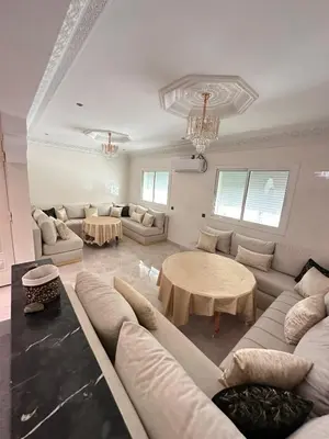a living room with a couch and a table at Fez Spacious Stay with Moroccan Artisanal Charm in Fès