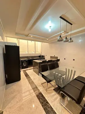 a kitchen with a glass table and black chairs at Fez Spacious Stay with Moroccan Artisanal Charm in Fès