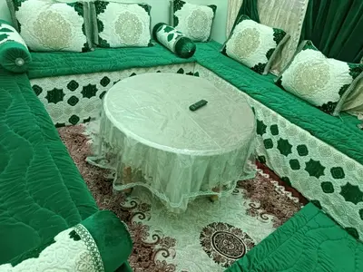 a green and white couch with a table on it at Appartement Aboumalik in Agdz