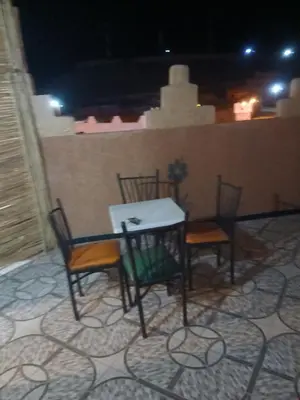 a table and chairs sitting on a patio at Appartement Aboumalik in Agdz