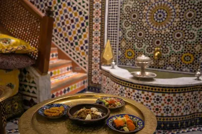 a table with plates of food on it in a room at Dar derb el miter in Fès