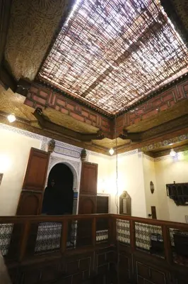 a person sitting in a room with a ceiling at Dar Na in Station Bab Ftouh