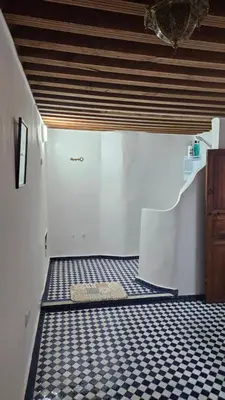 a bathroom with a black and white tiled floor at Dar Na in Station Bab Ftouh
