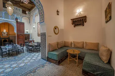 a living room with a couch and a table at Dar Na in Station Bab Ftouh