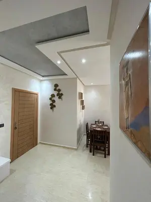 a hallway with a dining room with a table at Modern apartment near amenities in Fès