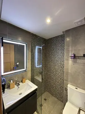 a bathroom with a sink and a shower at Modern apartment near amenities in Fès