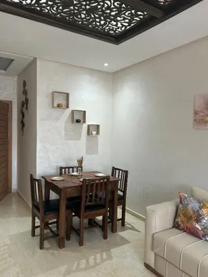 a dining room with a table and a couch at Modern apartment near amenities in Fès