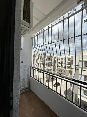a balcony with a large window with a view at Modern apartment near amenities in Fès