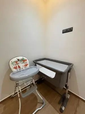 a hospital room with a bed and a high chair at Modern apartment near amenities in Fès
