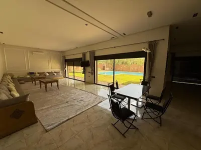 a living room with a couch and a table at Villa Adam in Srarhna