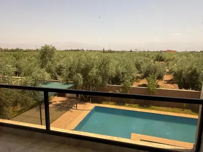 a view from the balcony of a house with a swimming pool at Villa Adam in Srarhna
