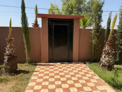 a house with a black door and a checkered driveway at Villa Adam in Srarhna
