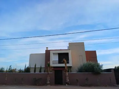 a house with two giraffes standing in front of it at Villa Adam in Srarhna