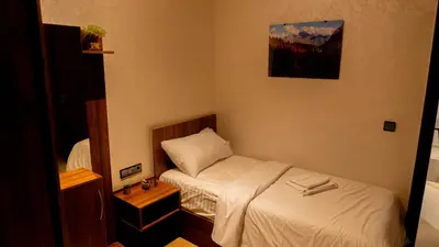 a small bedroom with a bed and a picture on the wall at TheHive Residence in Fès
