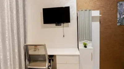 a room with a desk with a television on the wall at TheHive Residence in Fès