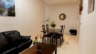 a living room with a table and a couch at TheHive Residence in Fès