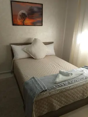 a bedroom with a bed with a pillow on it at TheHive Residence in Fès